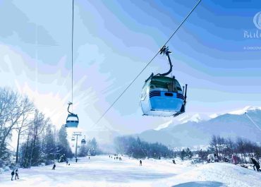 A ski lift carrying people up a snowy mountain, surrounded by a picturesque winter landscape.