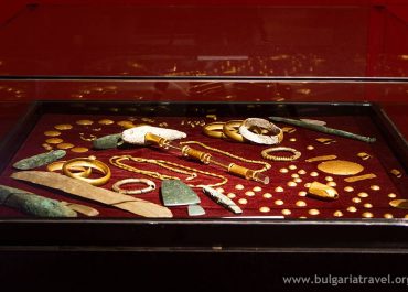 A display case showcasing exquisite gold and silver jewelry, radiating elegance and luxury.